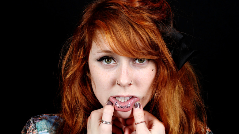 redhead with inner lip tattoo