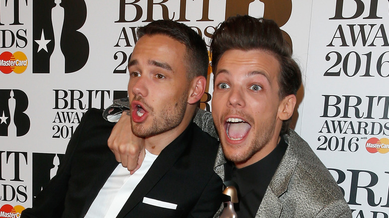 Louis Tomlinson and Liam Payne joke around at an event 