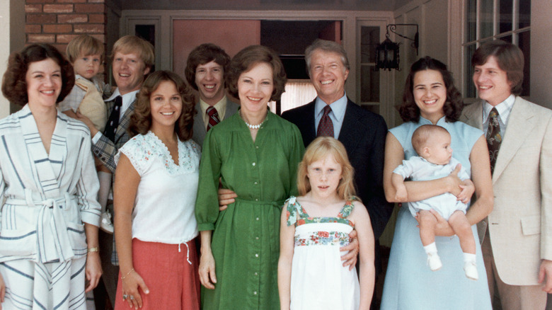 Jimmy Carter stands on his porch for a photo with his children and their spouses