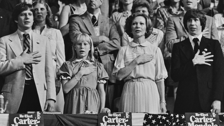 Amy, Chip, Jeff, and Rosalynn Carter say the Pledge of Allegiance 