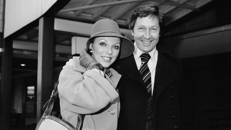 Joan Collins and Ron Kass smiling