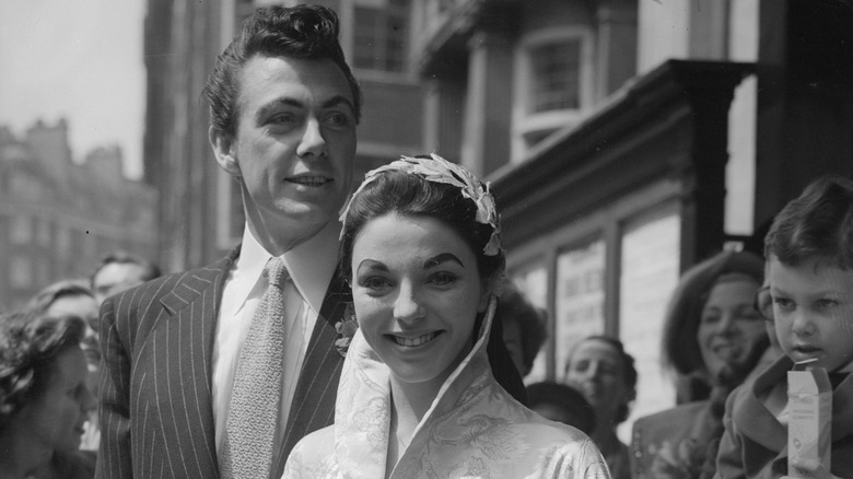 Joan Collins and Maxwell Reed smiling