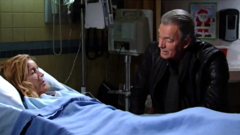 Victor Newman looks at Nikki in a hospital bed