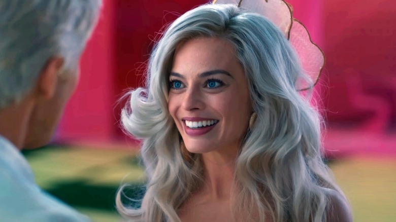 Margot Robbie grinning as Barbie