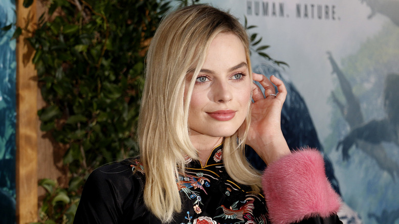 Margot Robbie tucking hair behind her ears