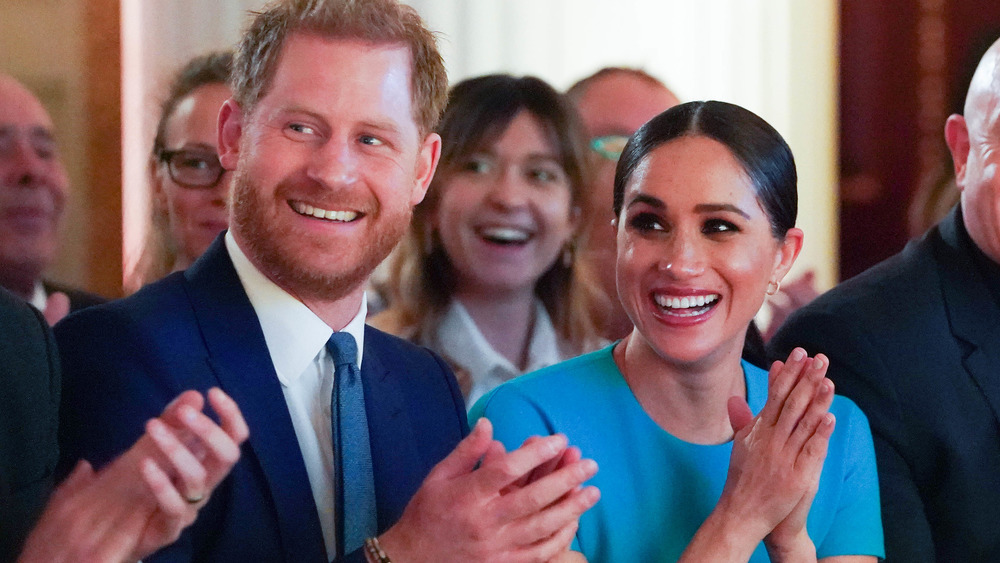 Prince Harry and Meghan Markle applauding