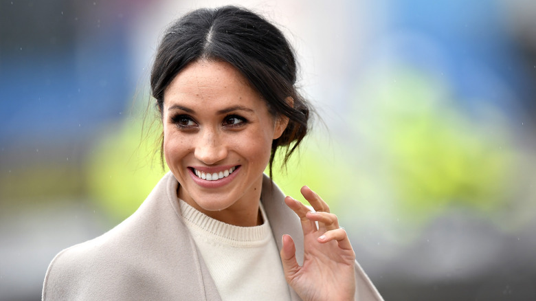 Meghan Markle smiling and waving