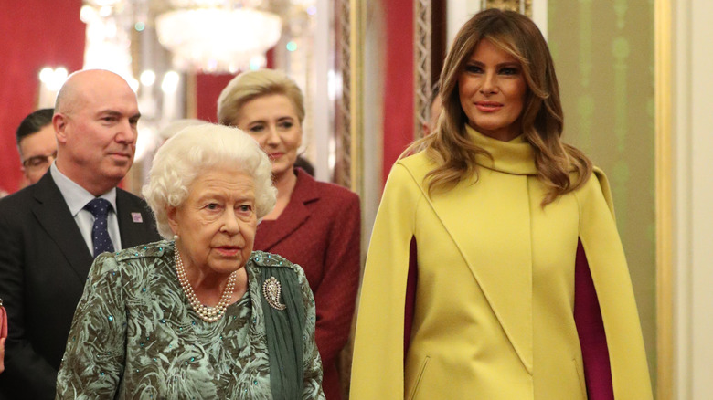 Queen Elizabeth II and Melania Trump walking 