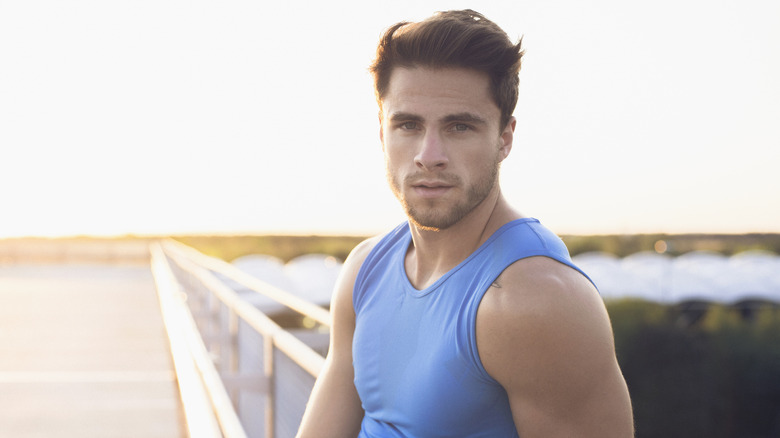 man in blue tank top