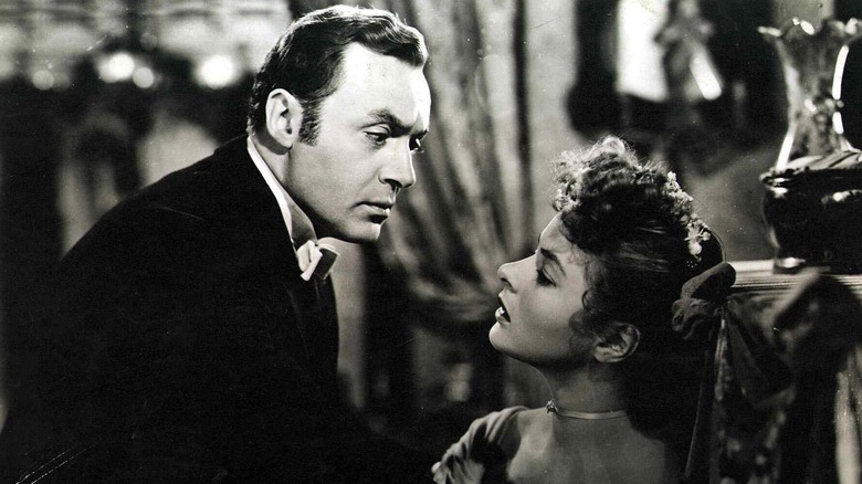 "Gaslight" 1944 film still: Charles Boyer leans over ingrid bergman