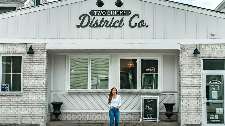 Mina in front of her retail store 