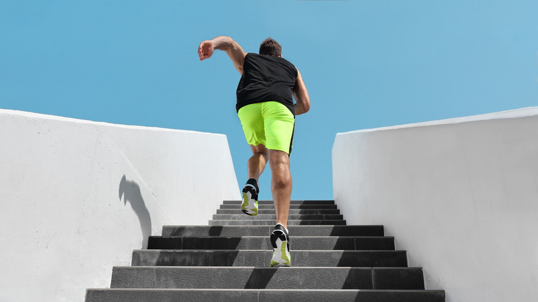 person doing cardio exercise by running stairs outside