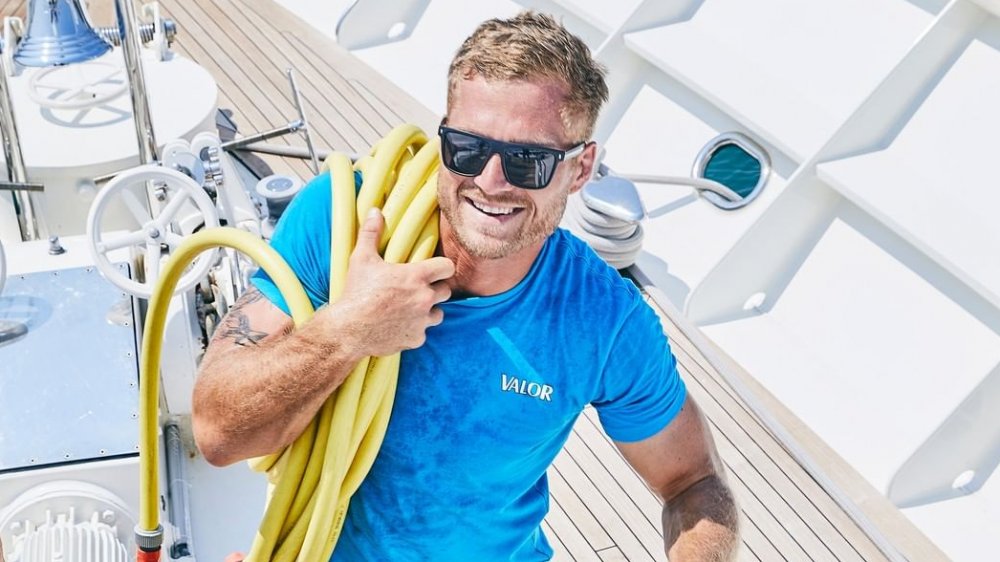 Below Deck star Brian carrying hose aboard the Valor