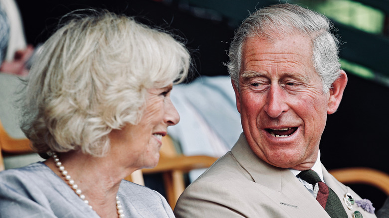 Charles and Camilla smiling at each other