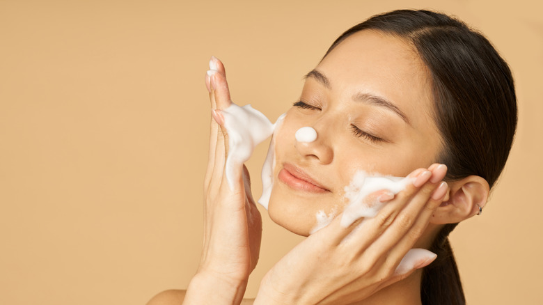 Woman applying cleanser