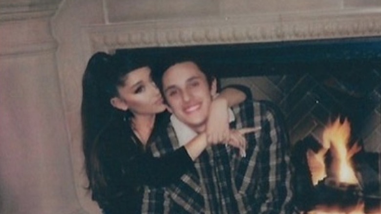 Ariana Grande hugging Dalton Gomez by fireplace