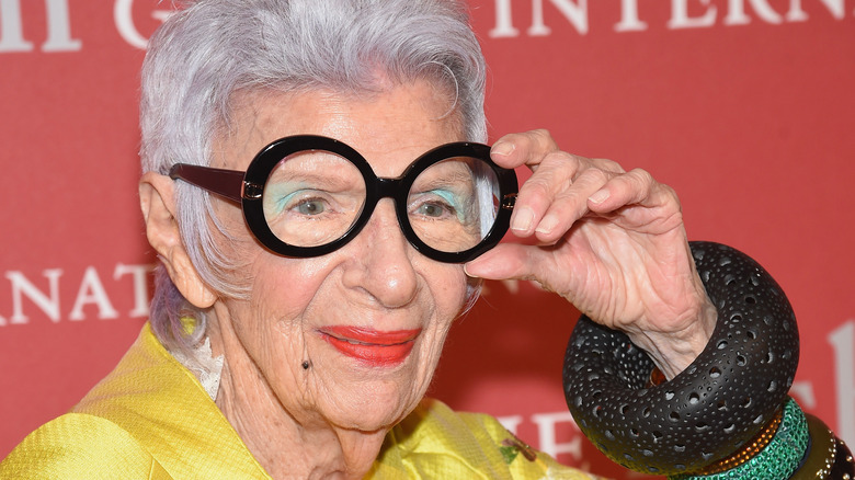 Iris Apfel adjusting glasses