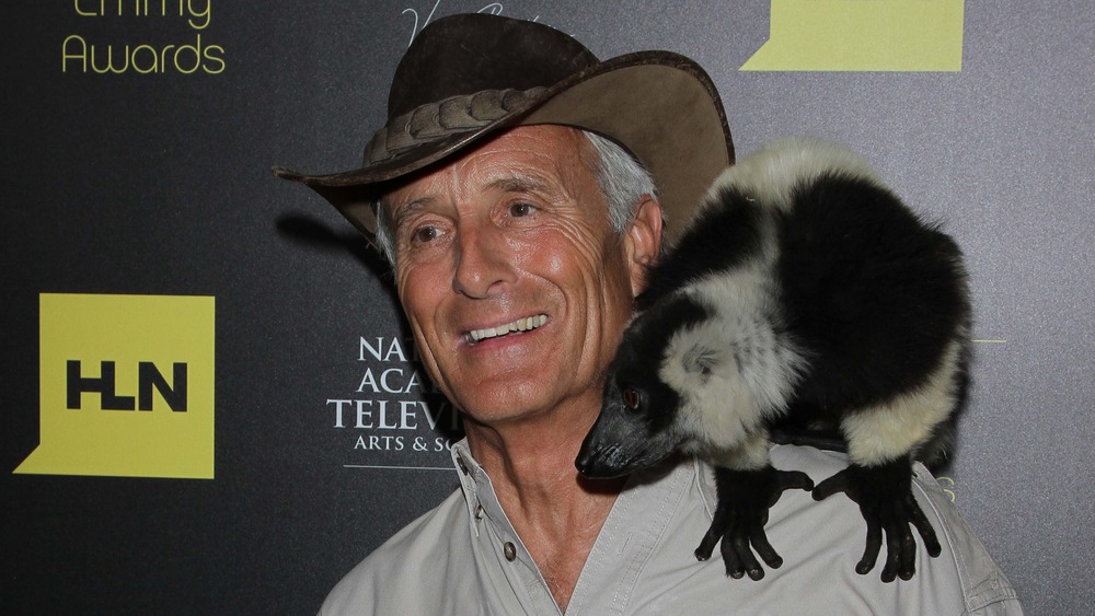 Jack Hanna posing with an animal on his shoulder