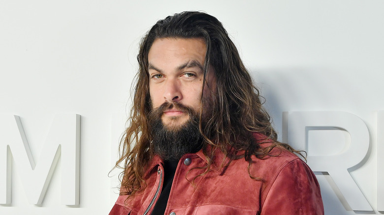 Jason Momoa wearing red jacket