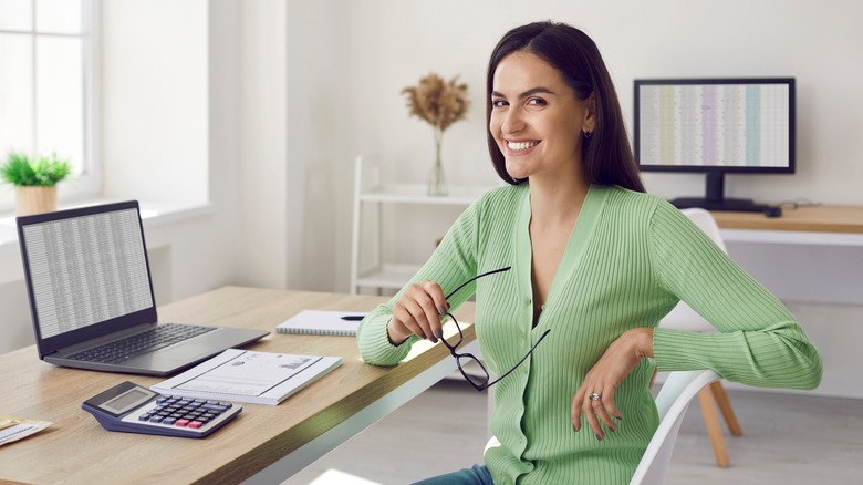 Female programmer smiling confidently while working on her computer