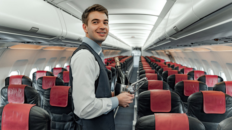 flight attendant holding champagne 