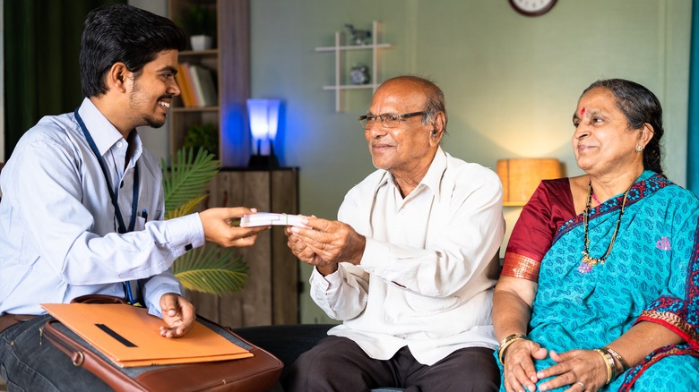 Indian male meeting with elderly couple