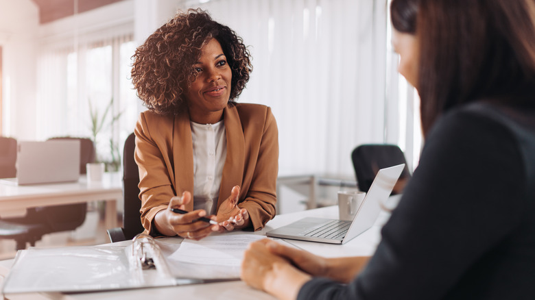 Black woman working with client