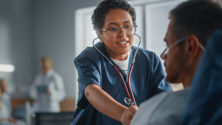 Focused Black healthcare professional performing patient exam