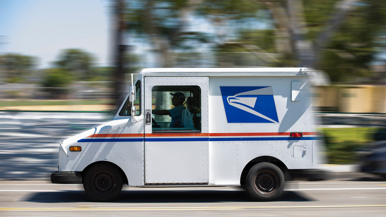 USPS truck driving on the road