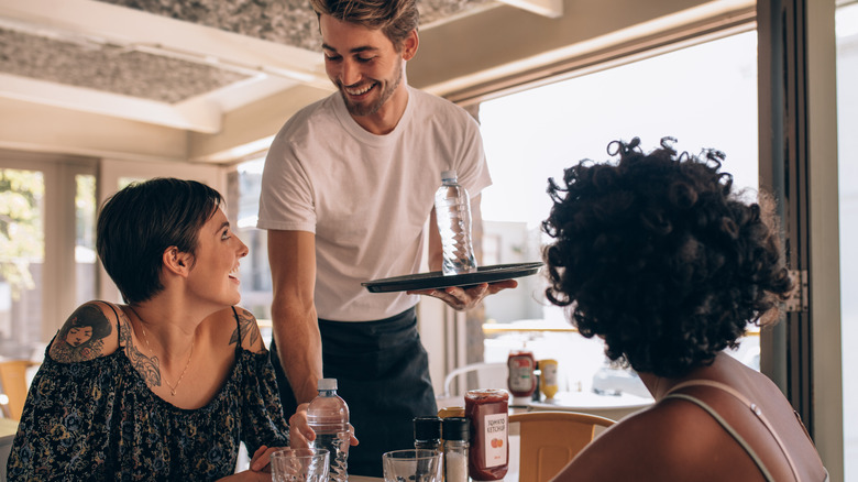 Waiter serving customers