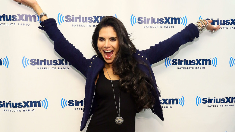 Joyce Giraud strikes a excited pose