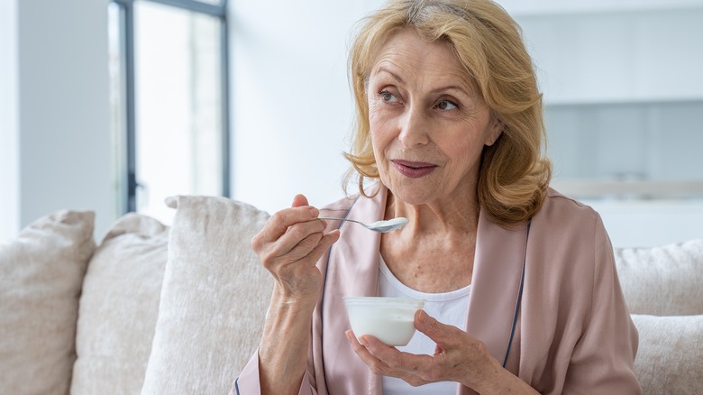 Older woman eating yogurt