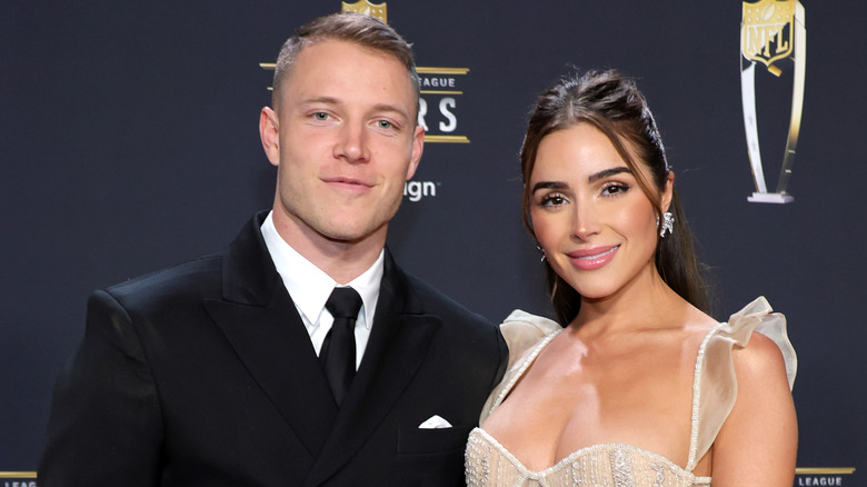 Christian McCaffrey and Olivia Culpo posing together