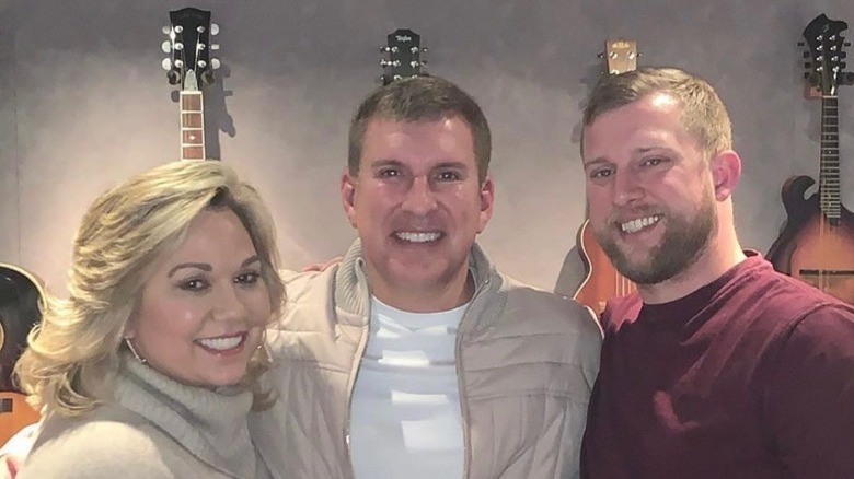 Kyle, Todd, and Julie Chrisley smiling