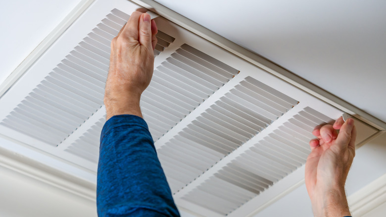 man opening a furnace system