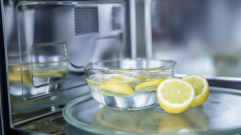 Bowl of lemons and water inside a microwave