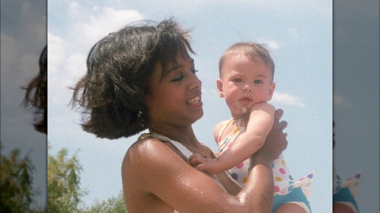 Maya Harris holding her daughter Meena as a baby