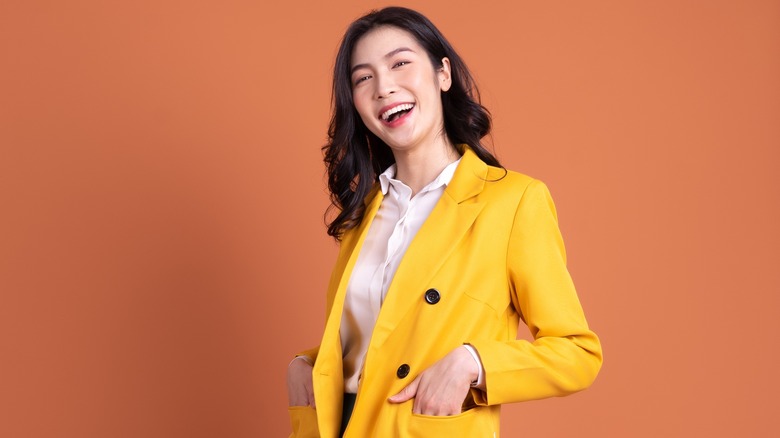 Woman laughing in yellow