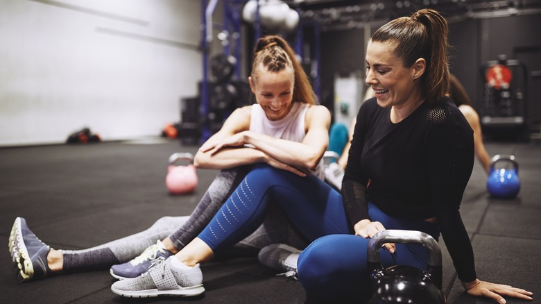 Two women laughing at the gym