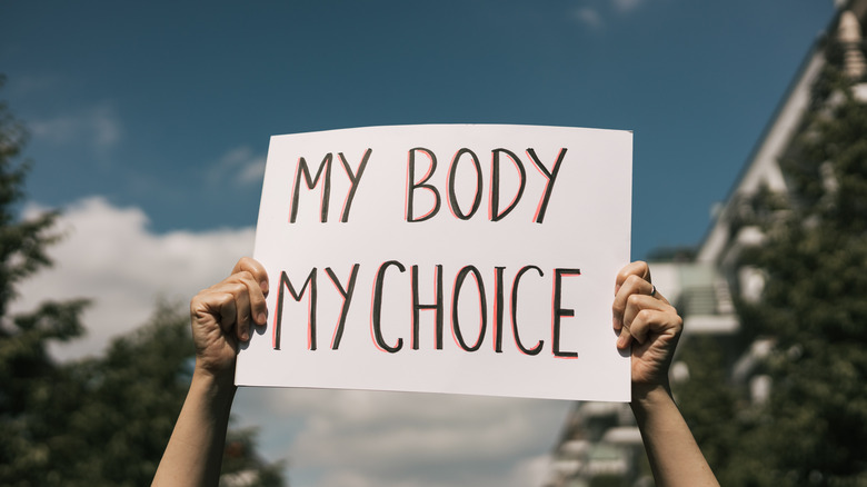 person holding up pro abortion protest sign 