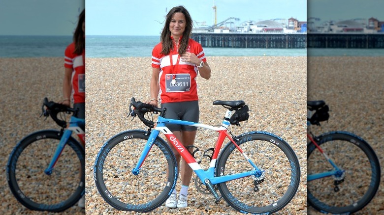 Pippa Middleton posing for a picture with her bicycle