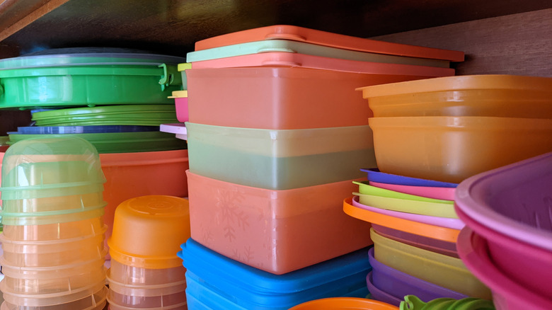 Plastic containers stacked in a cabinet 