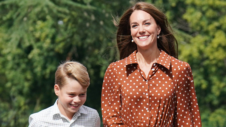 Prince George and Kate Middleton walk together, smiling