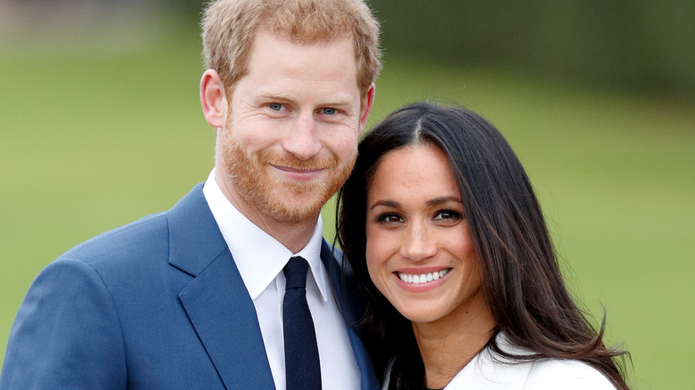 Prince Harry and Meghan Markle posing outdoors