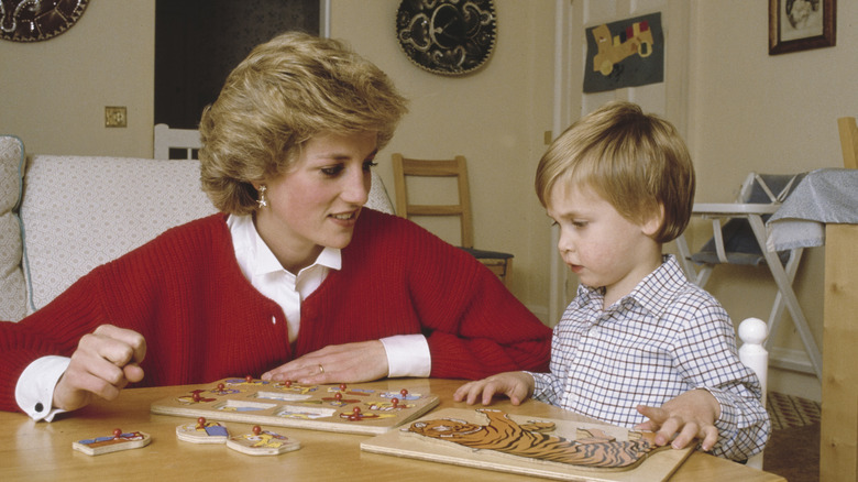 Princess Diana does a puzzle with Prince William