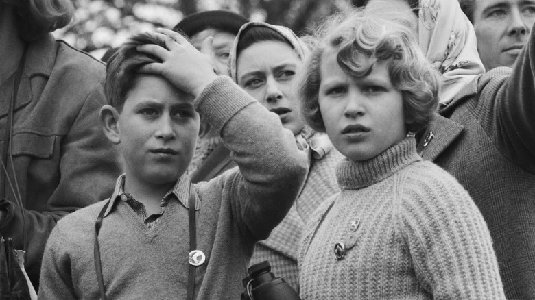 Young King Charles and Princess Anne observing something off-camera