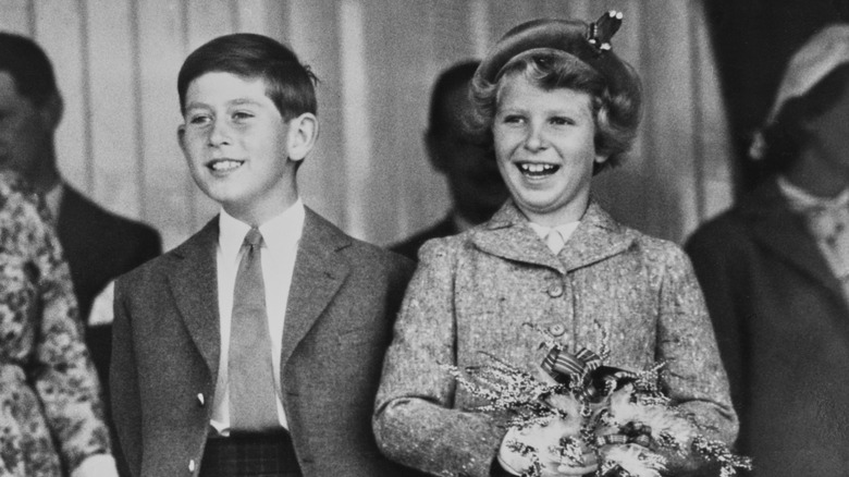 Young King Charles and Princess Anne smiling 