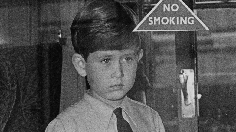 King Charles as a child gazing through a glass door