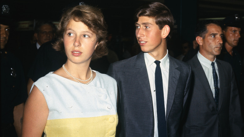 Teenage King Charles and Princess Anne looking to their right