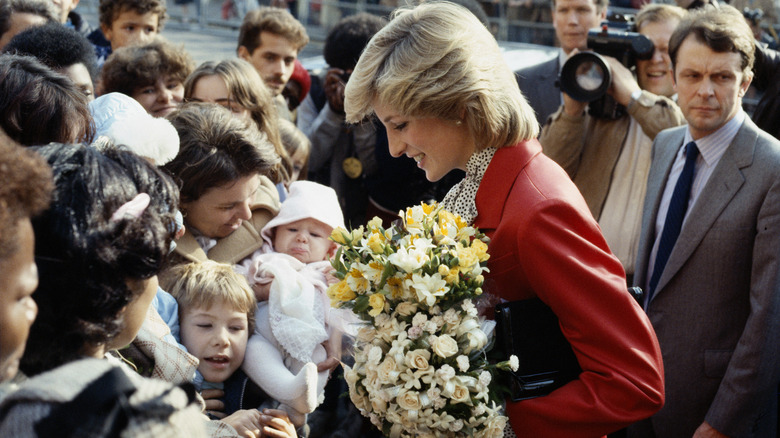 Princess Diana with flowers in a crowd